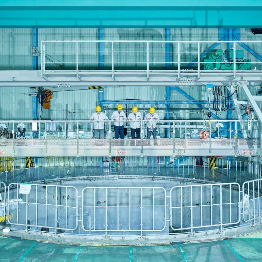 people in hard hats in industrial setting